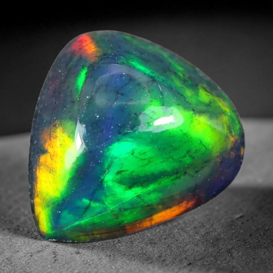 1.68ct Natural Ethiopian Welo Black Smoked Opal Cabochon Loose Gemstone, 81TG: This fully polished Ethiopian Welo opal features a dark smoked base with vivid, sweeping play-of-color shifting across its glossy dome surface, measured at 10.1x9.3x4.7mm. The black smoke treatment de