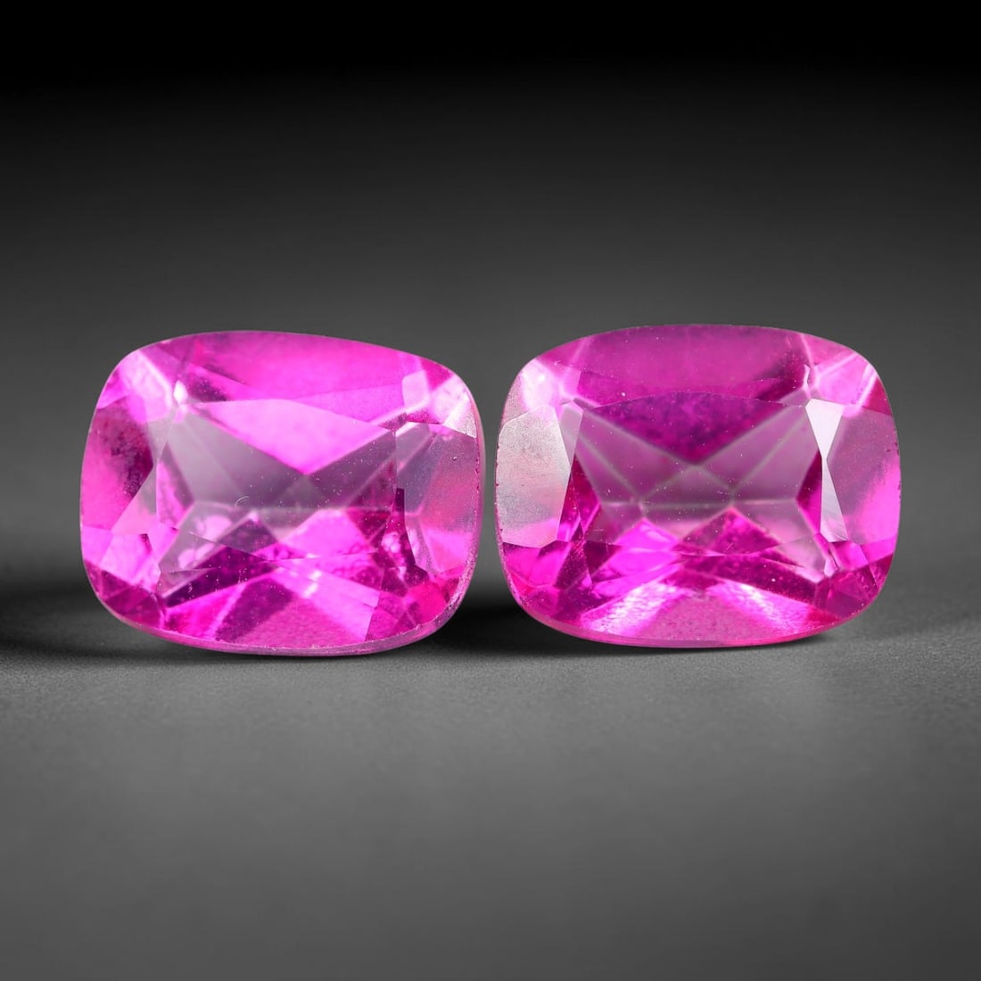 6.90ct Natural Pink Topaz Cushion Cut Matched Pair Loose Gemstones, 90TG: Natural pink topaz fashioned into a matched pair of cushion mixed cuts with polished table and brilliant pavilion facets. The stones display a saturated vivid hot pink body color with excellent transp
