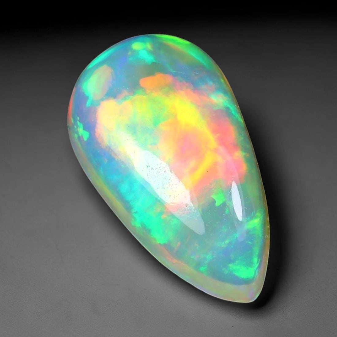 1.82ct Natural Ethiopian Welo Solid Opal Oval Cabochon Loose Gemstone, 47TG: Solid opal cabochon mined from Ethiopia's Welo opal deposits, polished into a smooth elongated oval dome with high reflective gloss. The translucent pale milky base hosts broad shifting play-of-color 