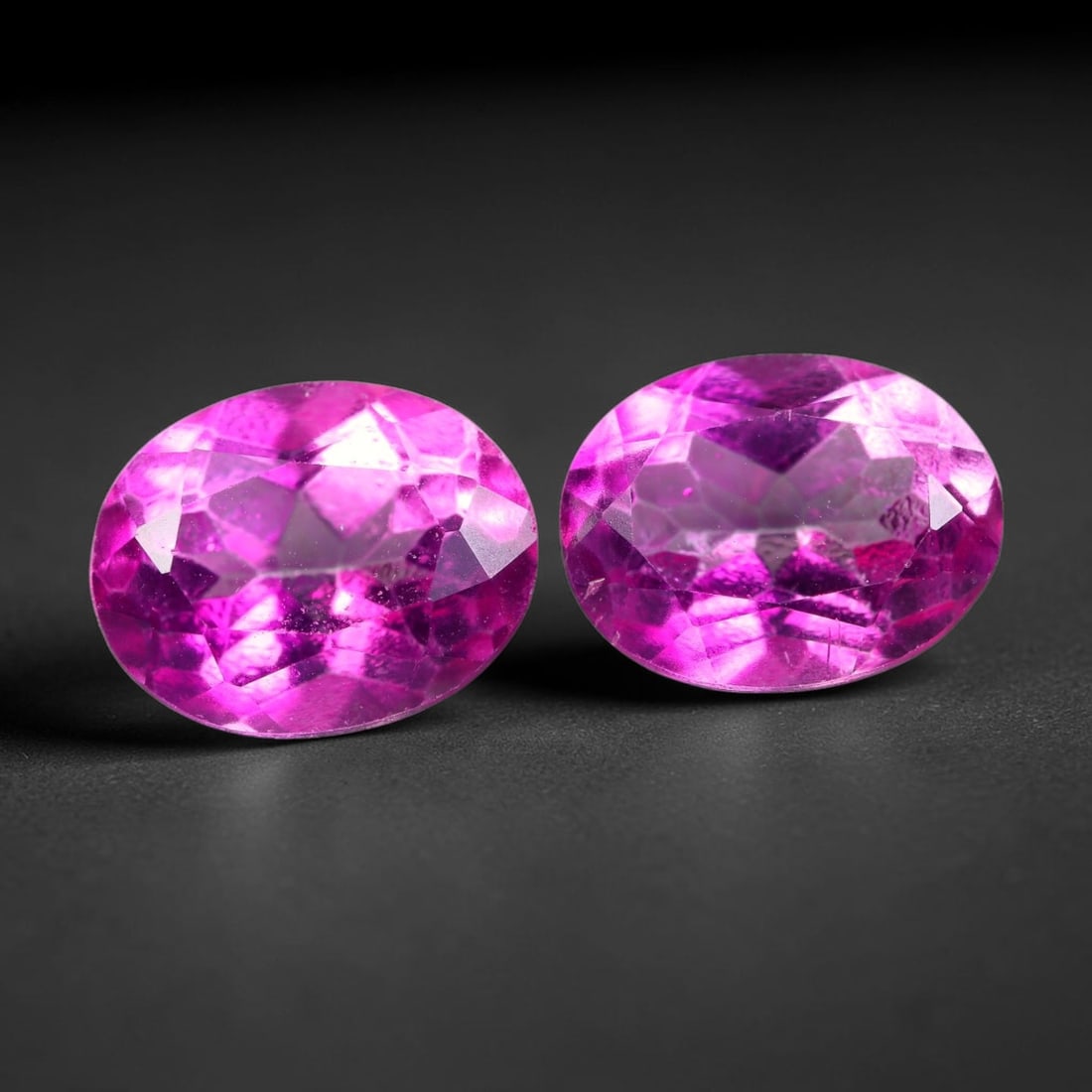4.59ct Natural Pink Topaz Oval Cut Matched Pair Loose Gemstones, 100TG: Natural pink topaz fashioned into a matched pair of oval mixed cuts with polished table and well-defined pavilion facets. The stones display a saturated vivid hot pink body color with good transparenc