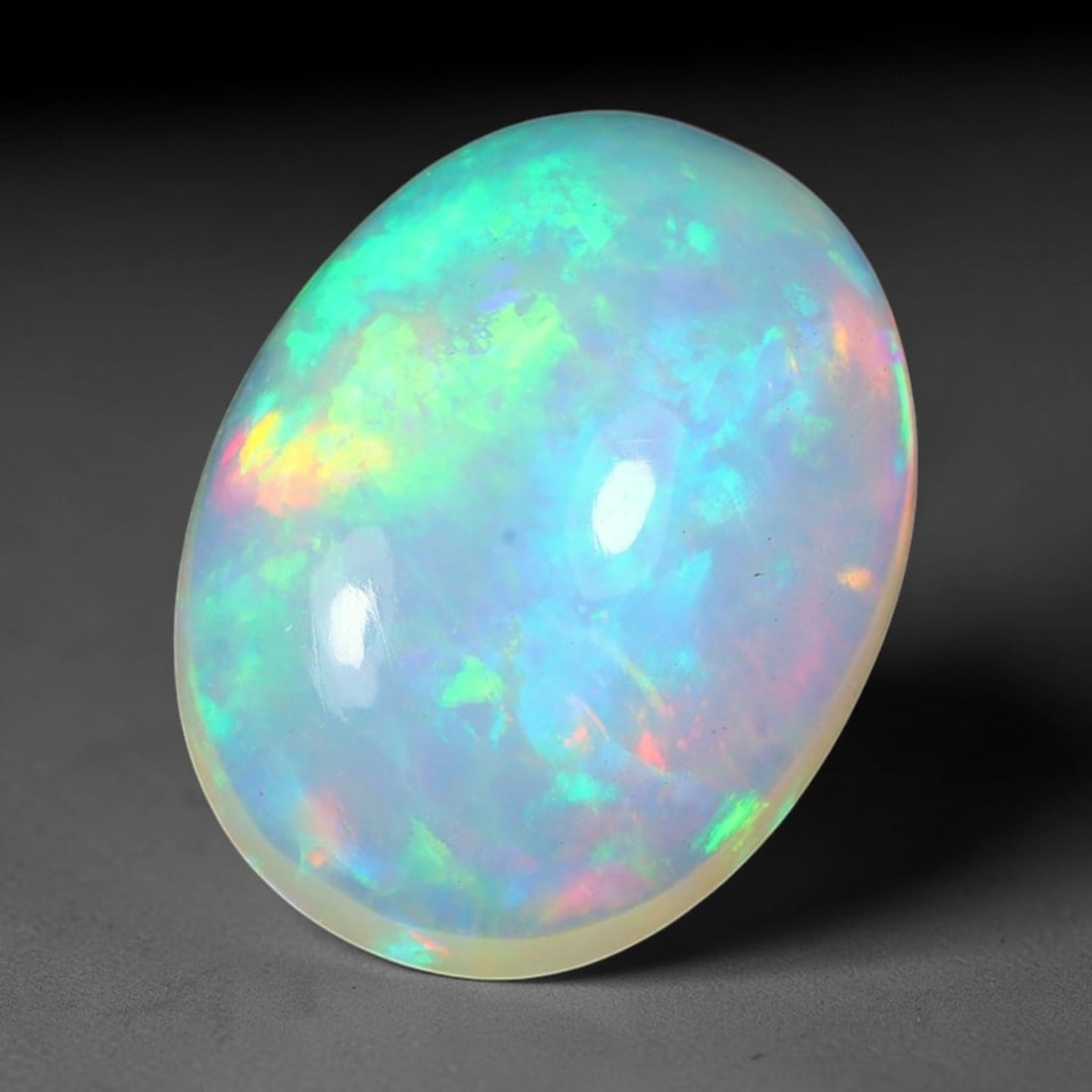 3.74ct Natural Ethiopian Welo Solid Opal Oval Cabochon Loose Gemstone, 27TG: Solid opal cabochon mined from Ethiopia's Welo opal deposits, polished into a smooth elongated oval dome with high reflective gloss. The translucent pale milky base hosts broad shifting play-of-color 