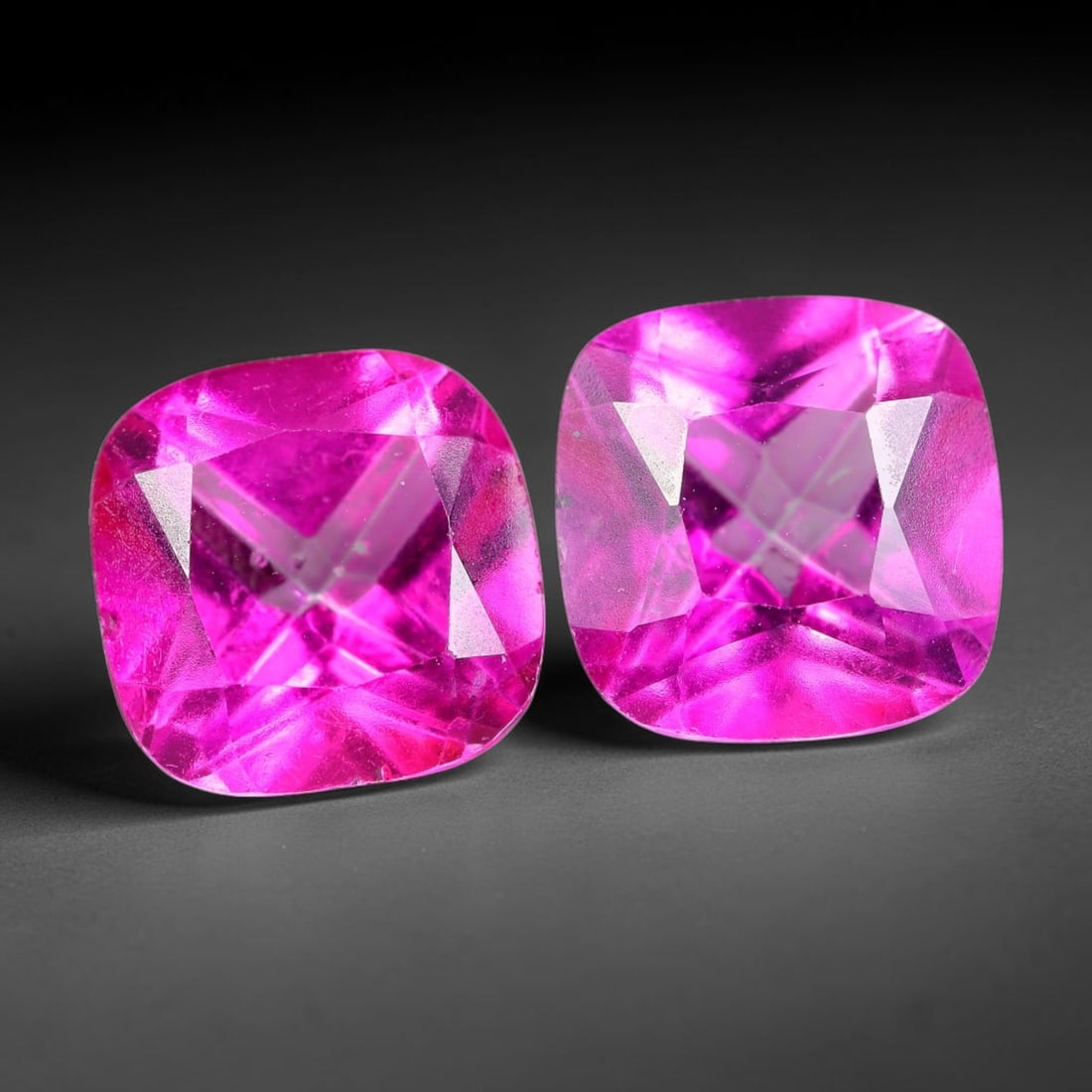 4.92ct Natural Pink Topaz Cushion Cut Matched Pair Loose Gemstones, 94TG: Natural pink topaz fashioned into a matched pair of cushion brilliant cuts with polished table and symmetrical pavilion facets. The stones exhibit a saturated vivid hot pink body color with high trans