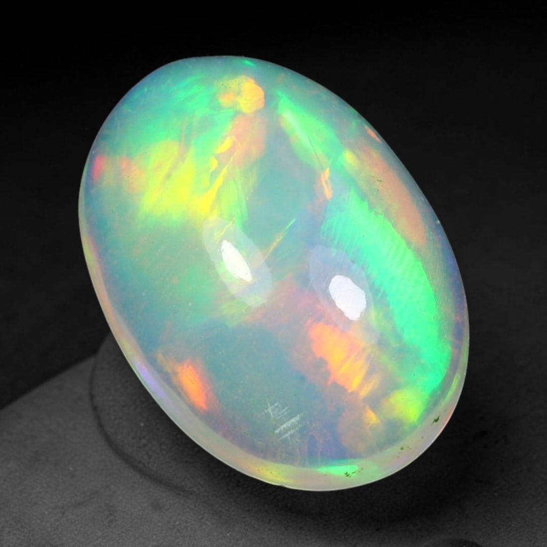 2.90ct Natural Multicolor Fire Ethiopian Welo Solid Opal Cabochon Loose Gemstone, 36TG: Formed from natural silica deposits within Ethiopian mineral veins, this solid opal cabochon is polished to a smooth domed surface that displays inherent light refraction traits. The stone carries wid