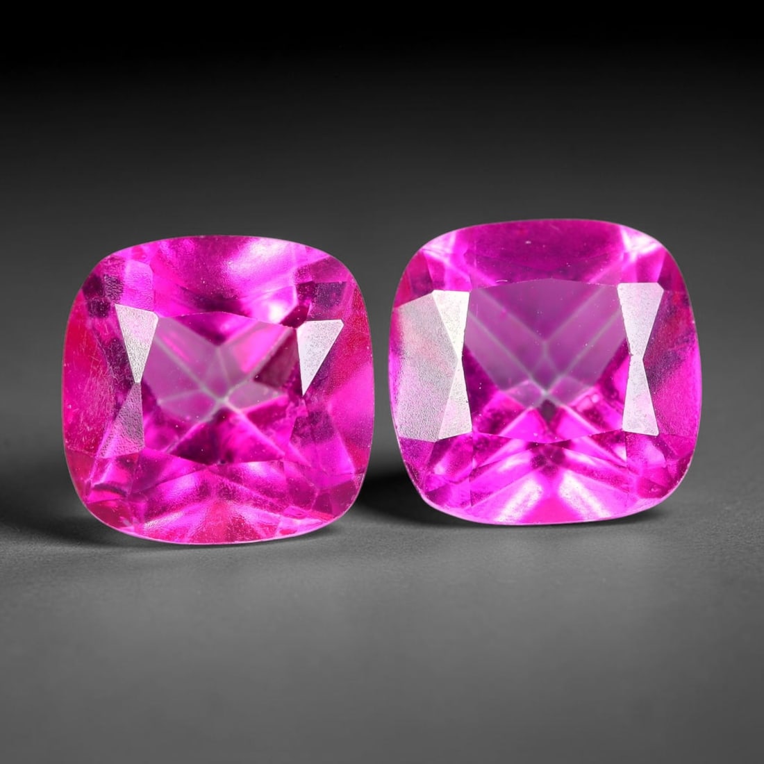 5.12ct Natural Pink Topaz Cushion Cut Matched Pair Loose Gemstones, 96TG: Natural pink topaz fashioned into a matched pair of cushion brilliant cuts with polished table and symmetrical pavilion facets. The stones exhibit a saturated vivid hot pink body color with high trans