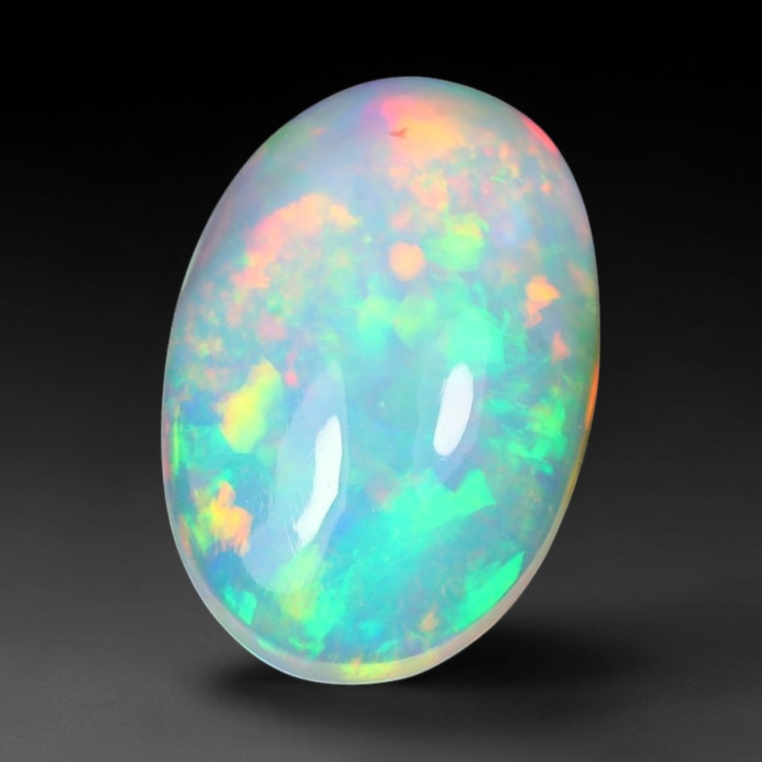 1.94ct Natural Ethiopian Welo Solid Opal Oval Cabochon Loose Gemstone, 62TG: Solid opal cabochon mined from Ethiopia's Welo opal deposits, polished into a smooth elongated oval dome with high reflective gloss. The translucent pale milky base hosts broad shifting play-of-color 