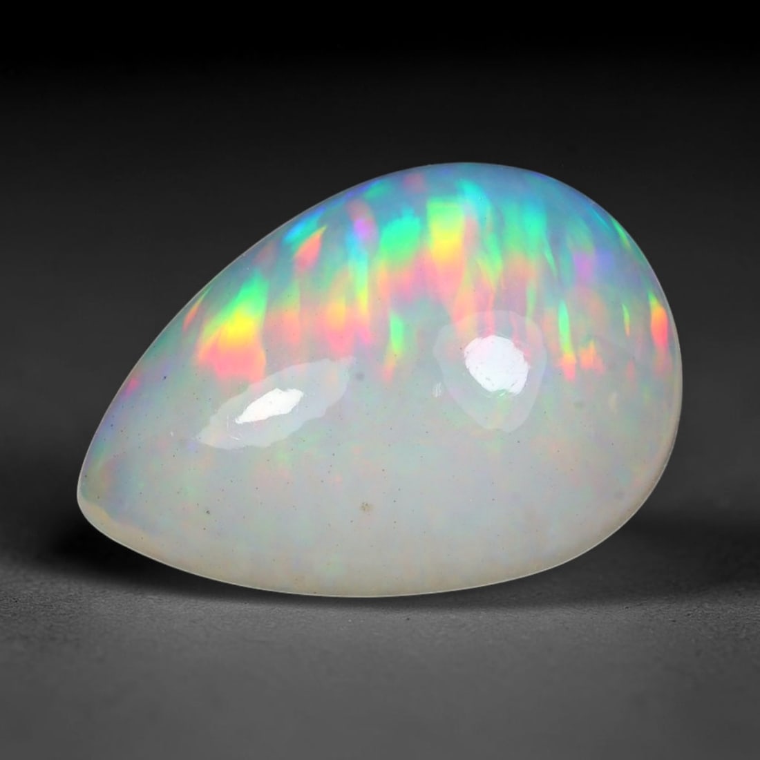4.62ct Natural Ethiopian Welo Solid Opal Oval Cabochon Loose Gemstone, 37TG: Solid opal cabochon mined from Ethiopia's Welo opal deposits, polished into a smooth elongated oval dome with high reflective gloss. The translucent pale milky base hosts broad shifting play-of-color 