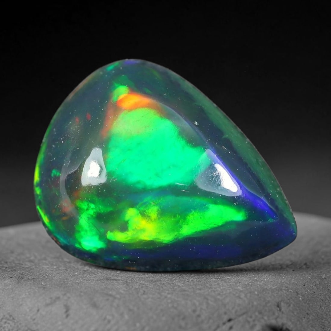 2.50ct Natural Ethiopian Welo Black Smoked Opal Cabochon Loose Gemstone, 71TG: This fully polished Ethiopian Welo opal features a dark smoked base with vivid, sweeping play-of-color shifting across its glossy dome surface, measured at 11.8x9.3x5.2mm. The black smoke treatment de
