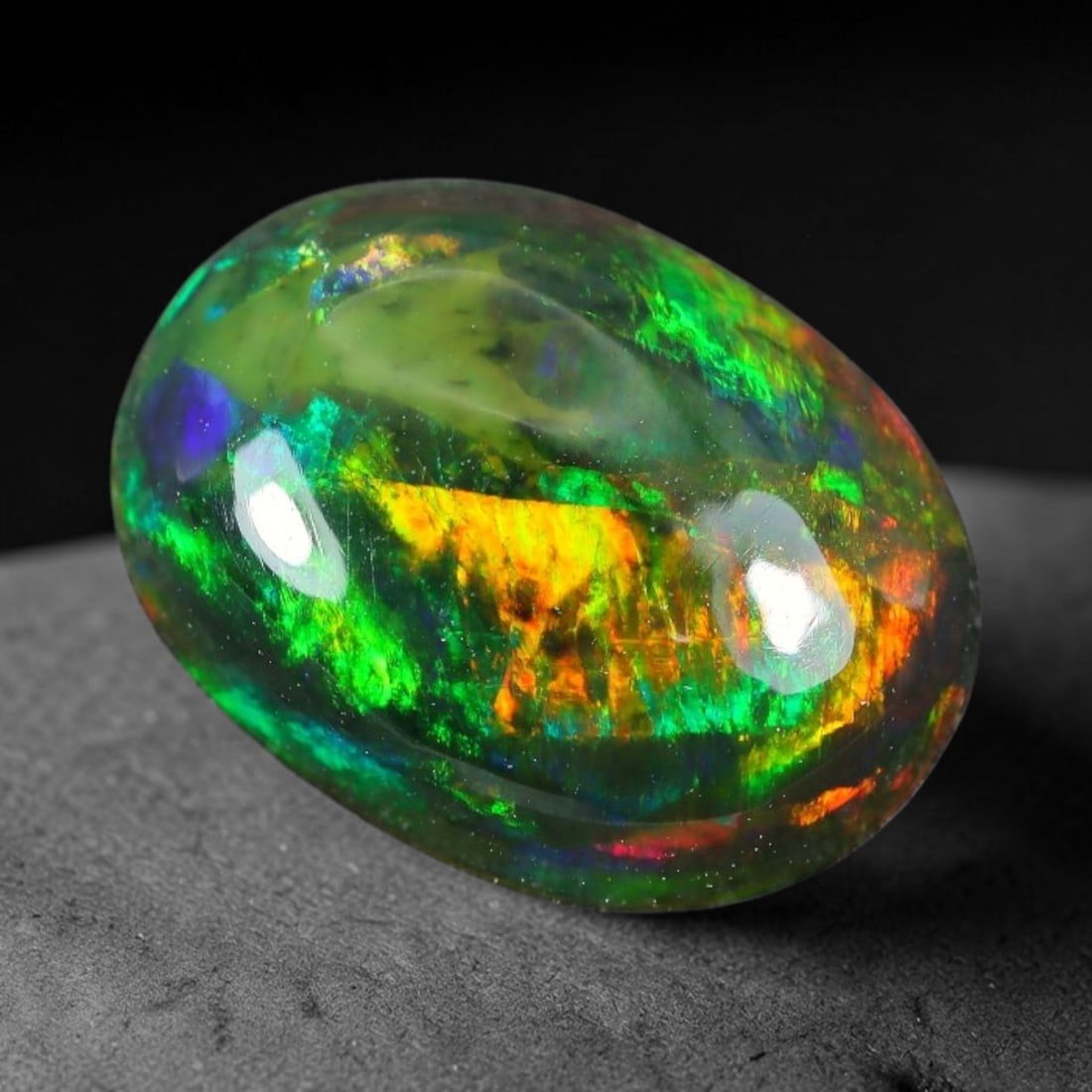 1.97ct Natural Ethiopian Welo Black Smoked Opal Cabochon Loose Gemstone, 84TG: This fully polished Ethiopian Welo opal features a dark smoked base with vivid, sweeping play-of-color shifting across its glossy dome surface, measured at 11.0x8.2x4.2mm. The black smoke treatment de