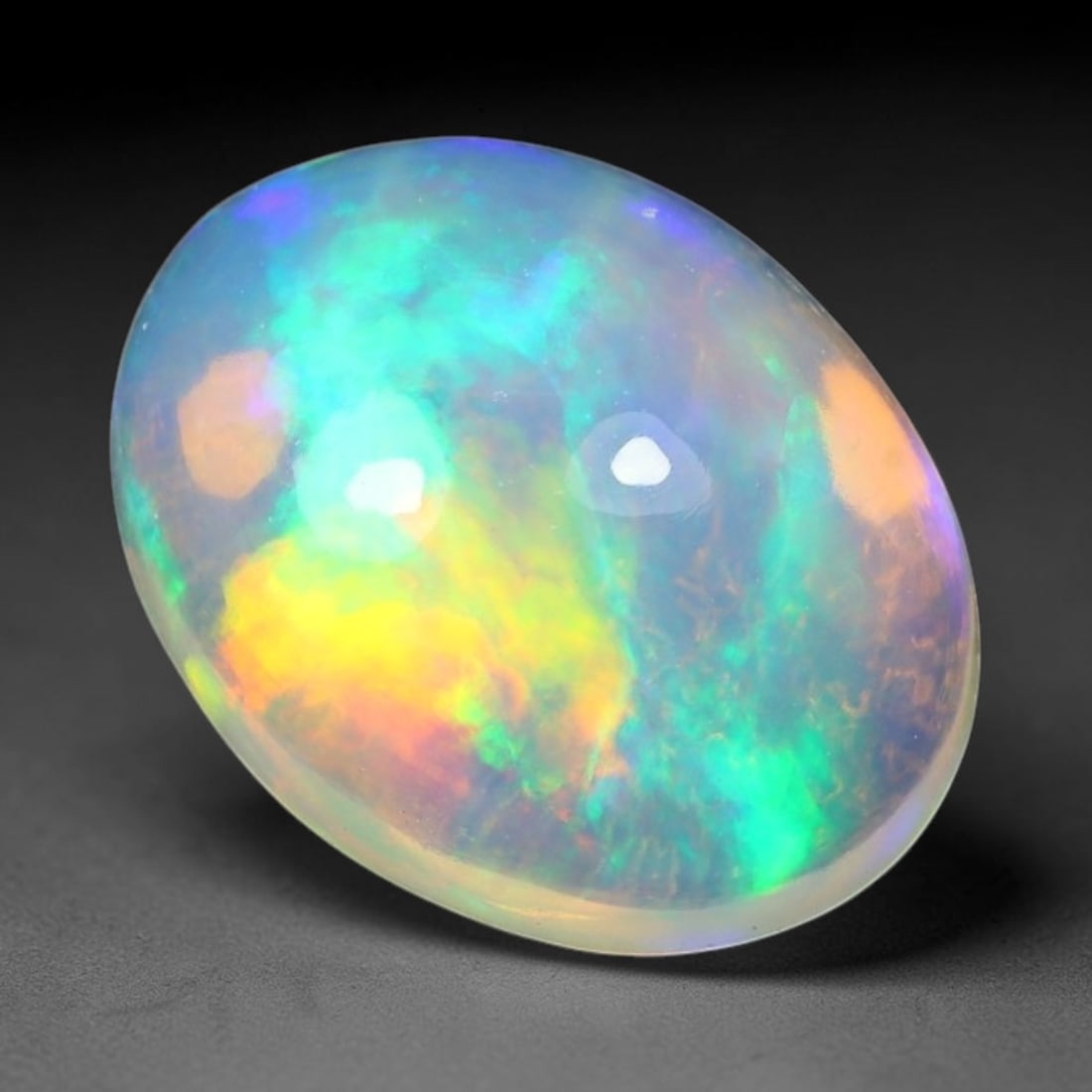 2.37ct Natural Ethiopian Welo Solid Opal Oval Cabochon Loose Gemstone, 54TG: Solid opal cabochon mined from Ethiopia's Welo opal deposits, polished into a smooth elongated oval dome with high reflective gloss. The translucent pale milky base hosts broad shifting play-of-color 