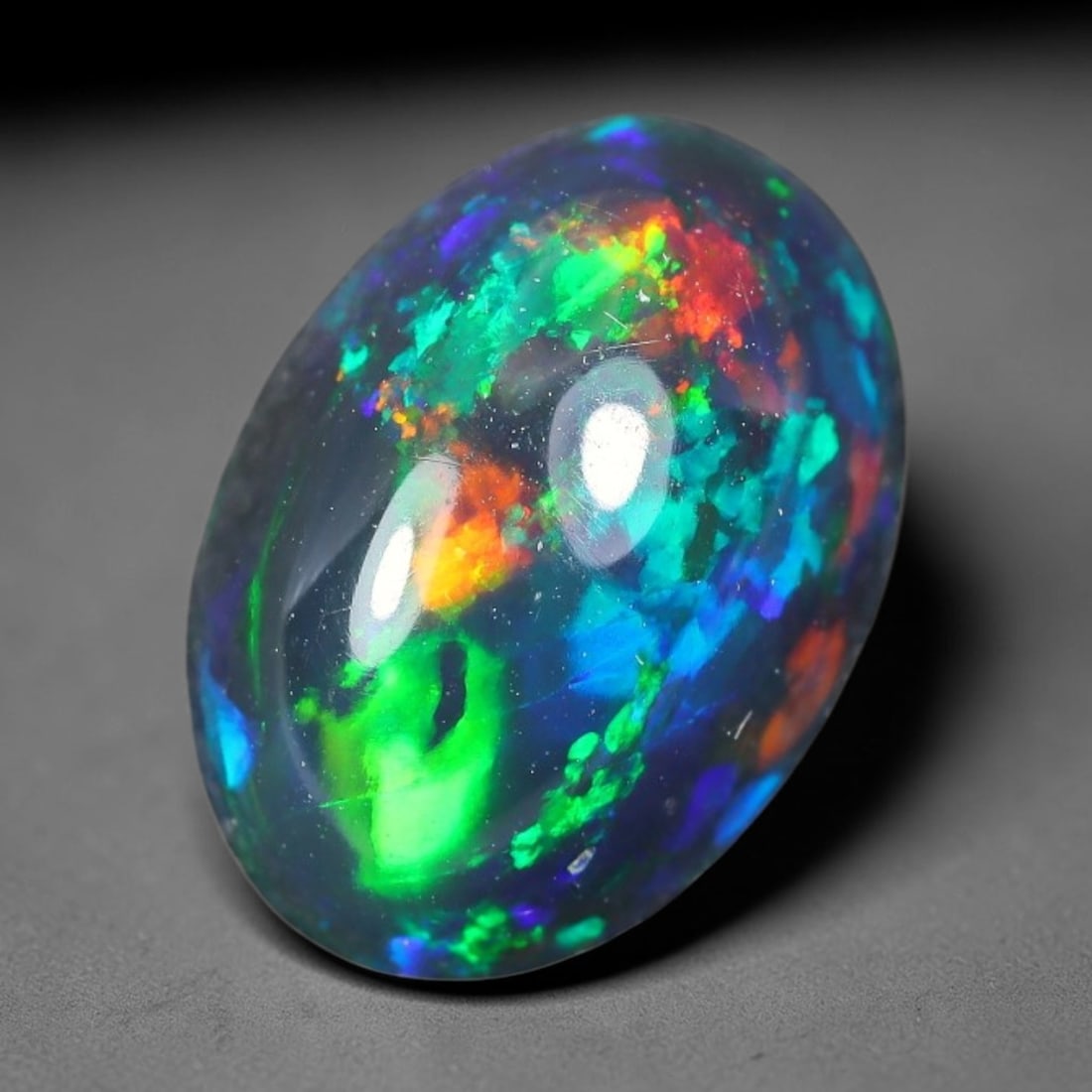 2.17ct Natural Ethiopian Welo Black Smoked Opal Cabochon Loose Gemstone, 86TG: This fully polished Ethiopian Welo opal features a dark smoked base with vivid, sweeping play-of-color shifting across its glossy dome surface, measured at 10.7x7.5x5.8mm. The black smoke treatment de