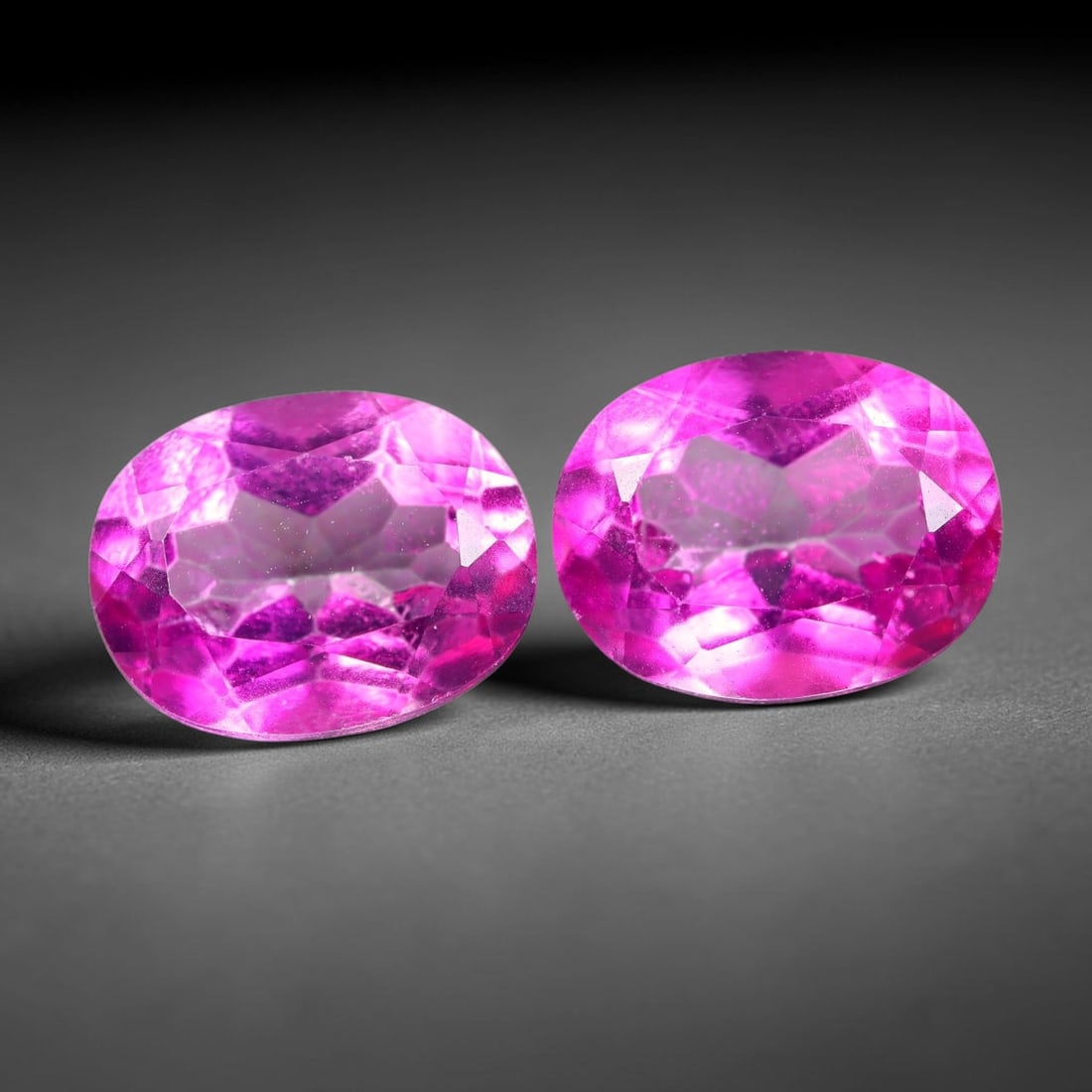4.84ct Natural Pink Topaz Oval Cut Matched Pair Loose Gemstones, 99TG: Natural pink topaz fashioned into a matched pair of oval mixed cuts with polished table and well-defined pavilion facets. The stones display a saturated vivid hot pink body color with good transparenc