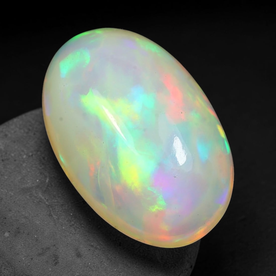 4.42ct Natural Ethiopian Welo Solid Opal Oval Cabochon Loose Gemstone, 33TG: Solid opal cabochon mined from Ethiopia's Welo opal deposits, polished into a smooth elongated oval dome with high reflective gloss. The translucent pale milky base hosts broad shifting play-of-color 