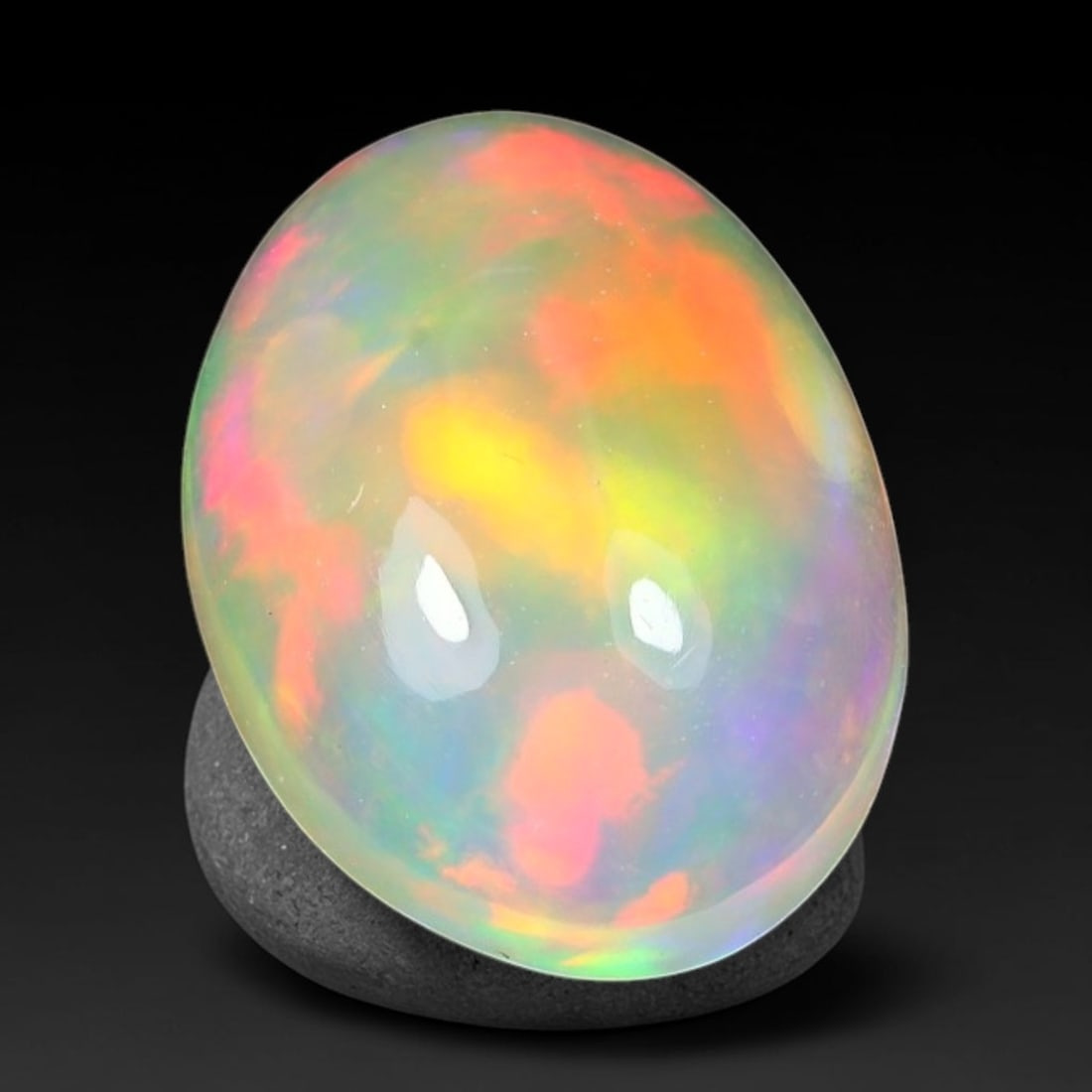 1.89ct Natural Ethiopian Welo Solid Opal Oval Cabochon Loose Gemstone, 39TG: Solid opal cabochon mined from Ethiopia's Welo opal deposits, polished into a smooth elongated oval dome with high reflective gloss. The translucent pale milky base hosts broad shifting play-of-color 