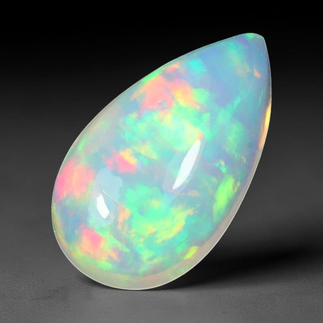 1.60ct Natural Ethiopian Welo Solid Opal Oval Cabochon Loose Gemstone, 64TG: Solid opal cabochon mined from Ethiopia's Welo opal deposits, polished into a smooth elongated oval dome with high reflective gloss. The translucent pale milky base hosts broad shifting play-of-color 