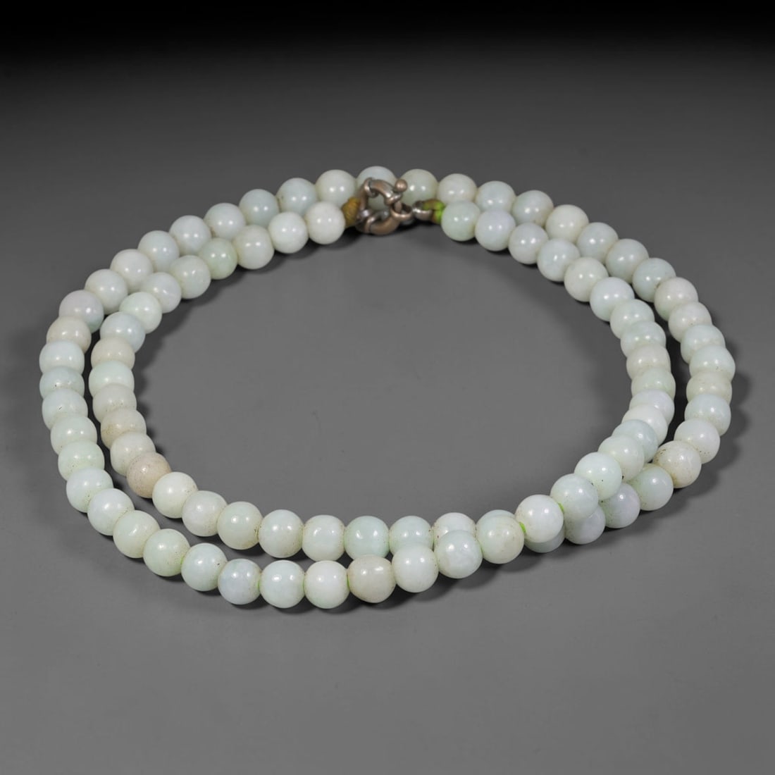 Natural Burmese Type A Pale Celadon Jadeite Jade Round Bead Necklace, 37TF: Polished from natural Burmese Type A jadeite, this necklace features smooth round pale celadon jadeite beads measuring 7.7mm, fitted with a metal clasp. It displays soft milky white blended with delic