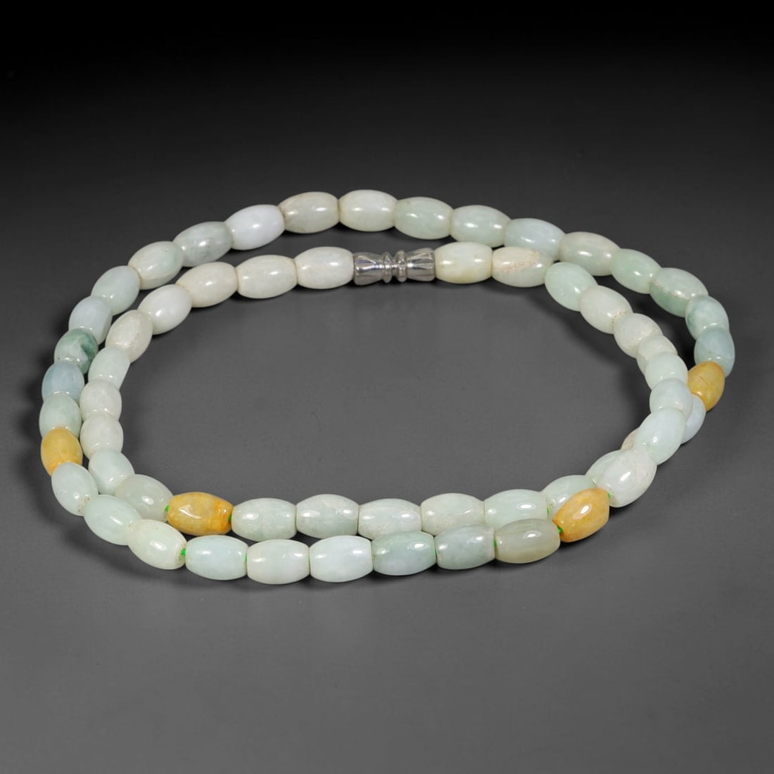 Natural Burmese Type A Multi-Tone Oval Jadeite Jade Bead Necklace, 10TF: Smooth round natural Burmese Type A jadeite beads measuring 5.7mm, with soft pale sage-green hues and subtle natural tone variation throughout the strand. Equipped with a sterling silver lobster clasp