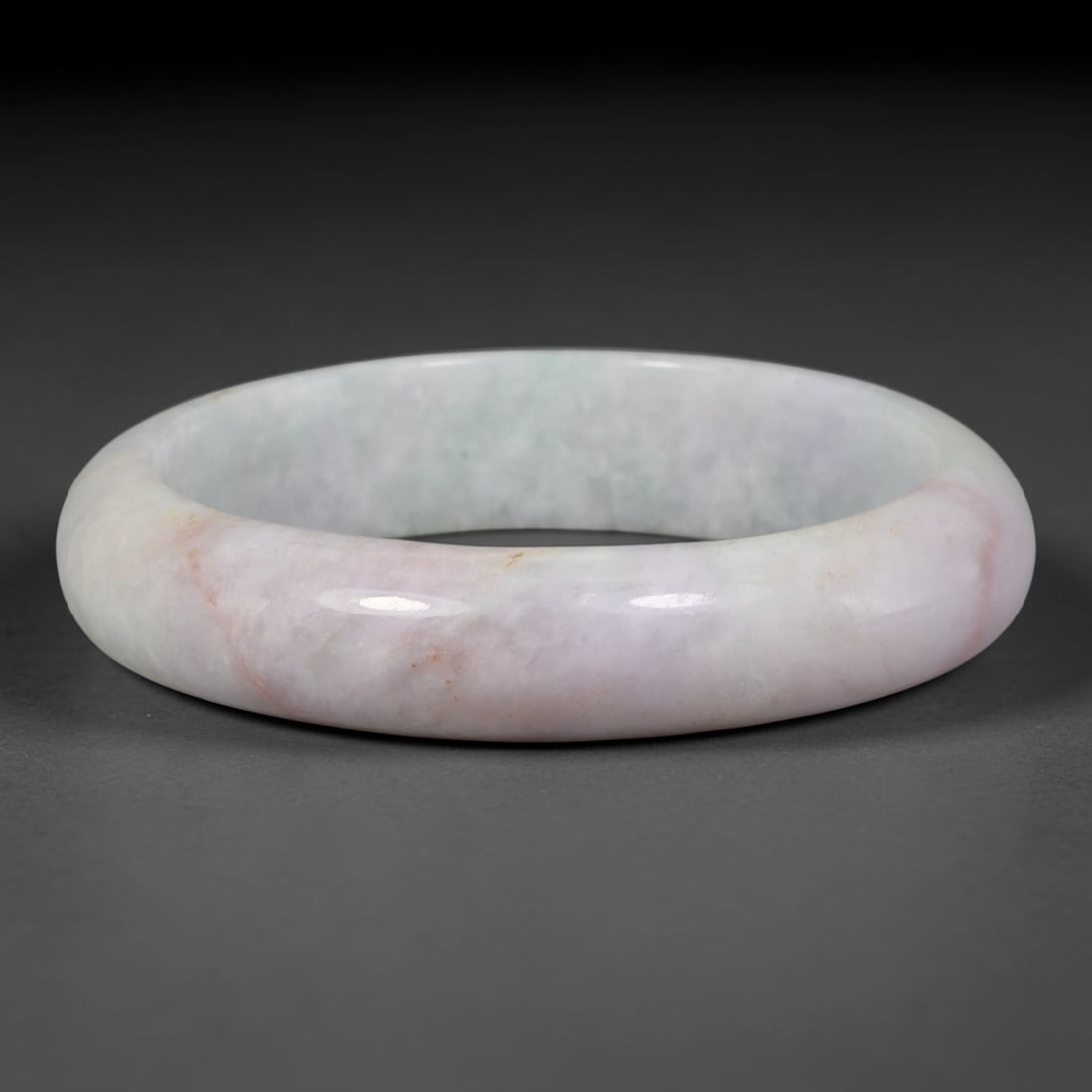 Natural Burmese Type A Pale Lavender Blush Floating Green Jadeite Jade Bangle Bracelet, 61TD: Polished from natural Burmese jadeite, this solid bangle has a soft pale lavender blush base marked with faint reddish mineral veining and subtle wisps of pale floating green within the matrix. Formed