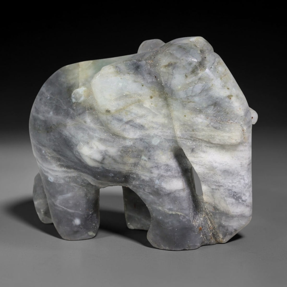 Natural Burmese Type A Grey Cloudy Jadeite Jade Elephant Carving, 1TC: Hand-carved from natural Burmese Type A jadeite, this elephant figurine measures 47x27mm. It features blended grey and milky white cloudy banding with subtle natural mineral flecks and stone veining a
