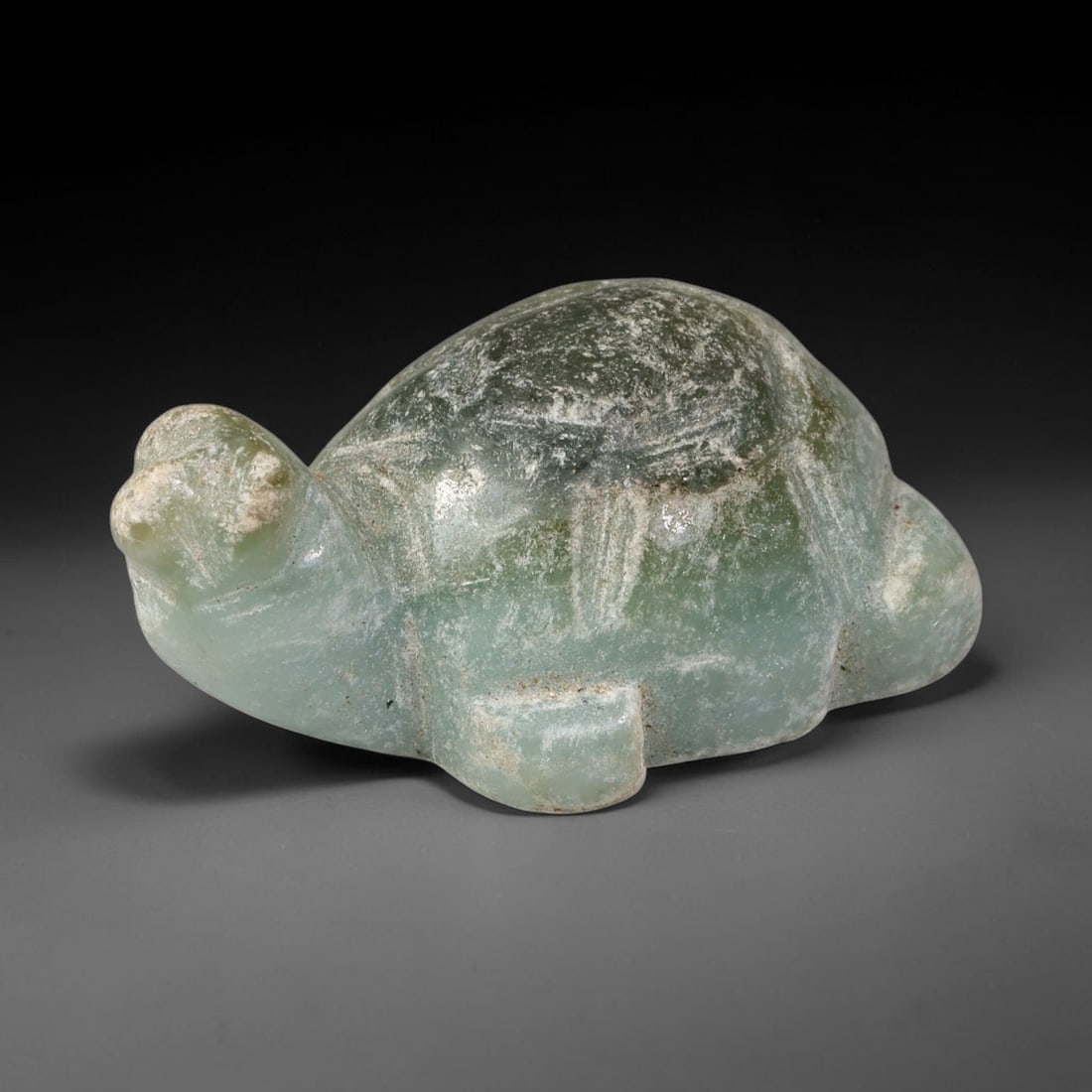 Natural Burmese Type A Pale Celadon Green Jadeite Jade Turtle Carving, 95TC: Hand-carved from natural Burmese Type A jadeite, this turtle figurine measures 33x20mm. It displays soft pale celadon green tones with darker green mottling and subtle surface patina across the shell,