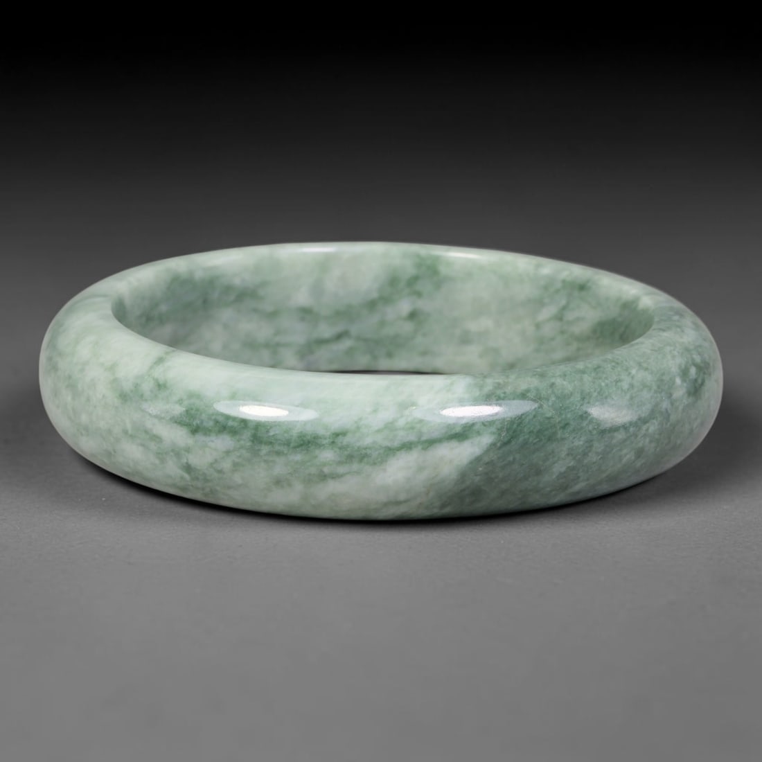 Natural Burmese Type A Misty Cloud Floating Green Jadeite Jade Bangle Bracelet, 72TD: Polished from natural Burmese jadeite, this solid bangle carries a soft pale green base interwoven with flowing misty cloud-like green veining that drifts across the stone matrix. Formed in a traditio