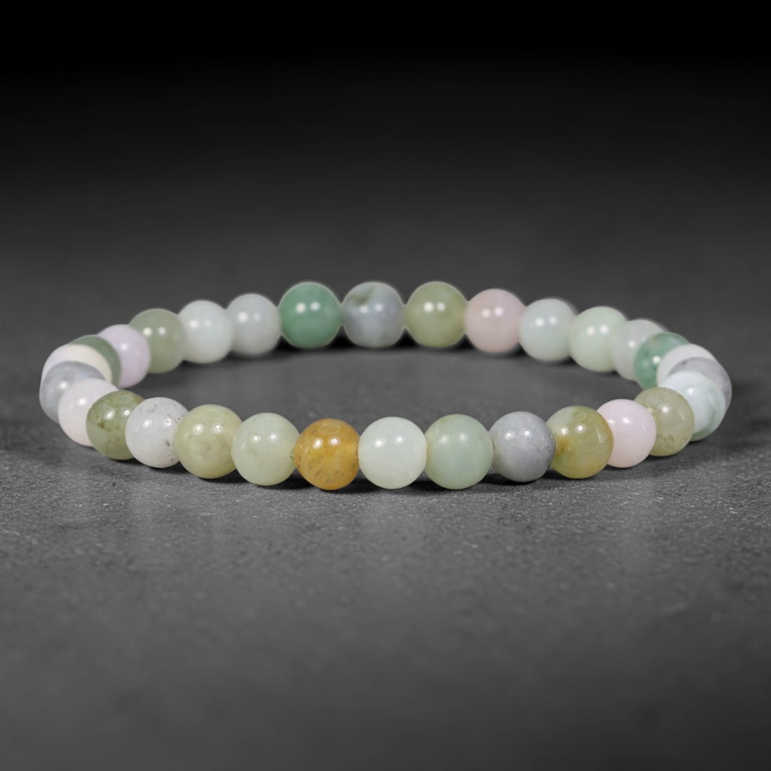 Natural Burmese Type A Jadeite Jade Multicolour Round Bead Bracelet, 88TK: Polished from natural Burmese Type A jadeite, this bracelet features smooth round multicolour beads measuring 7.6mm. It presents a soft palette of pale green, white, light lavender, grey and warm yell