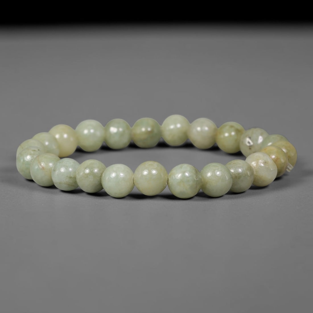 Natural Burmese Type A Pale Celadon Jadeite Jade Round Bead Bracelet, 86TK: Polished from natural Burmese Type A jadeite, this bracelet features smooth round pale celadon beads measuring 8.7mm. It carries soft pale celadon tones with subtle natural veining and faint earthy mi