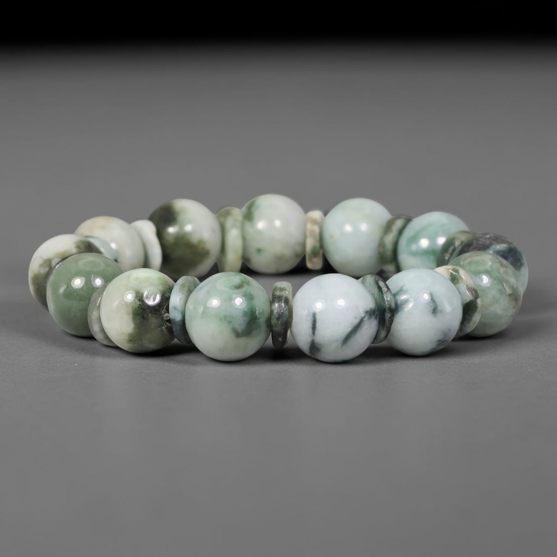 Natural Burmese Type A Floating Green Mottled Jadeite Jade Round Bead Bracelet, 78TK: Polished from natural Burmese Type A jadeite, this bracelet features smooth round floating green mottled beads measuring 13.6mm, accented with matching jadeite spacer discs. It displays milky white ba
