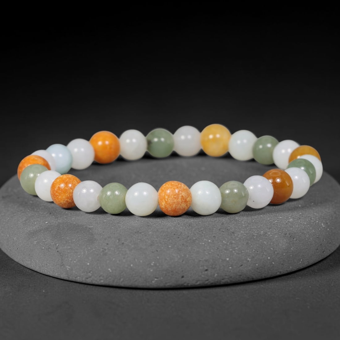 Natural Burmese Type A Jadeite Jade Multicolour Round Bead Bracelet, 95TK: Polished from natural Burmese Type A jadeite, this bracelet features smooth round multicolour beads with the largest bead measuring 7.6mm. It displays a harmonious mix of white, pale green, yellow and