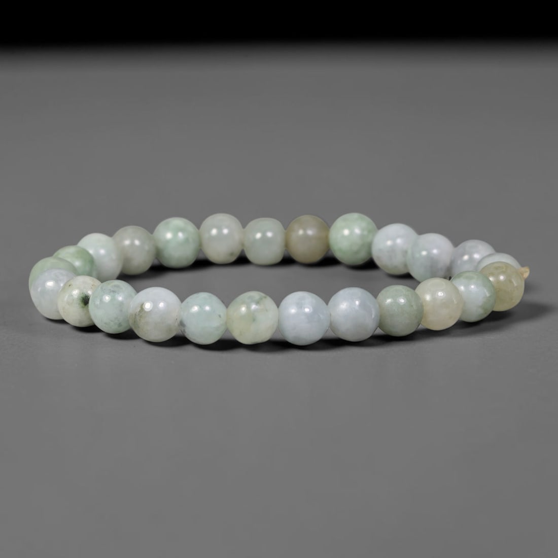 Natural Burmese Type A Jadeite Jade Pale Green Round Bead Bracelet, 92TK: Polished from natural Burmese Type A jadeite, this bracelet features smooth round pale green beads measuring 8.4mm. It carries soft muted pale green and off-white tones with subtle natural clouding an