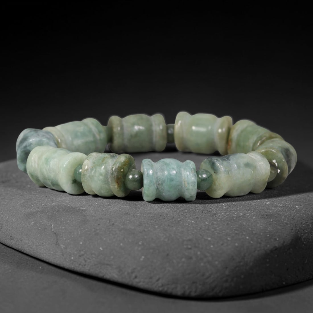 Natural Burmese Type A Celadon Barrel Shape Jadeite Jade Bead Bracelet, 80TK: Polished from natural Burmese Type A jadeite, this bracelet features carved celadon barrel shape beads measuring 11.7mm, separated by small round jadeite spacer beads. It carries soft celadon green to