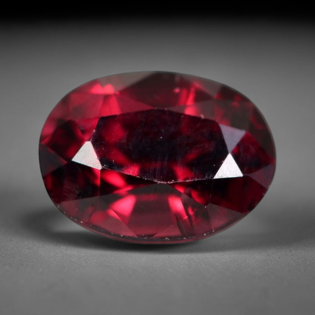 1.37 Carats Natural Deep Burgundy Red Garnet Oval Faceted Loose Gemstone, 20WJ: This timeless faceted garnet boasts a luxuriously deep burgundy red tone that glows with vivid crimson fire across its precisely polished reflective facets. Fine natural micro mineral specks are scatt