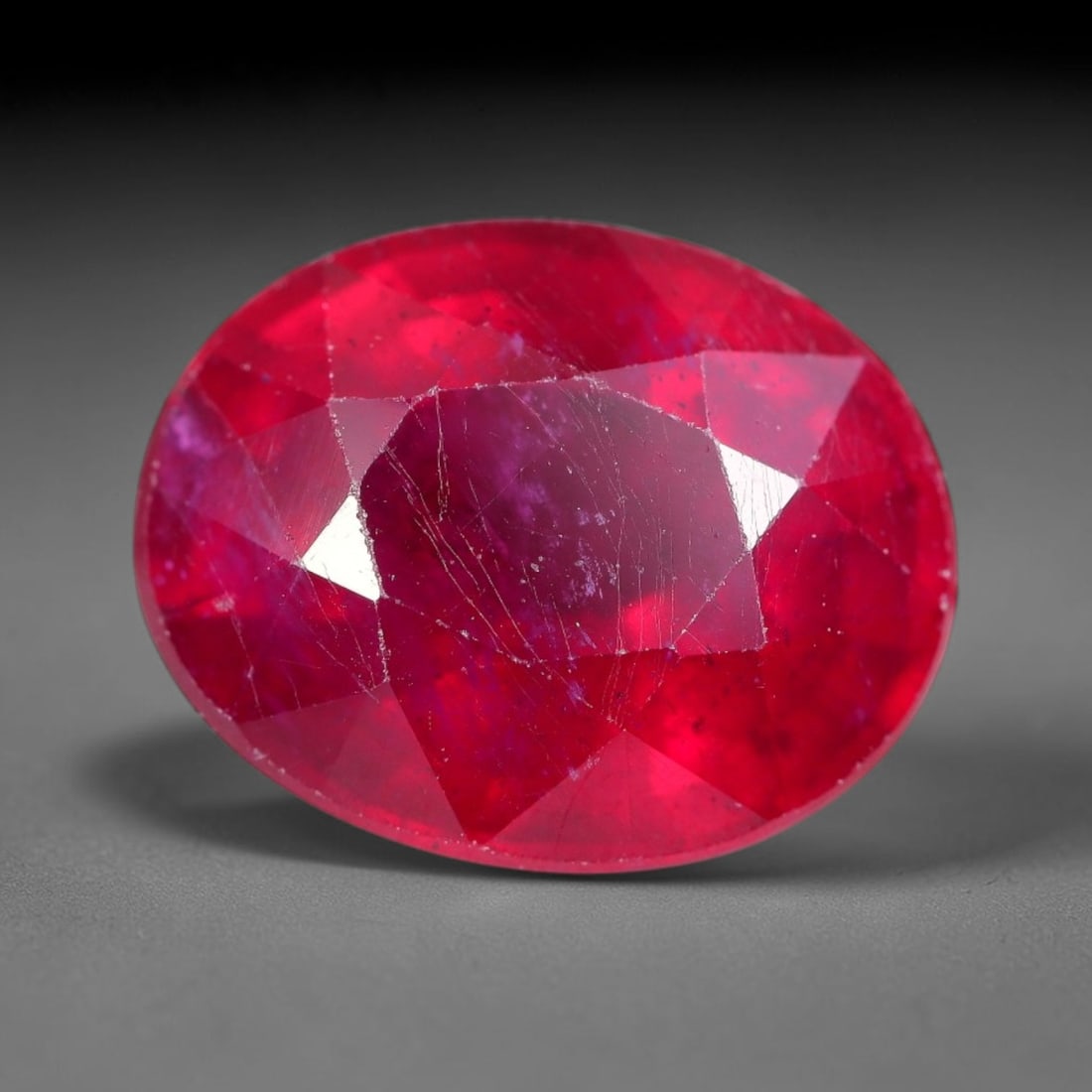 7.93 Carats Natural Madagascar Ruby Oval Faceted Loose Gemstone, 42XM: This sizable natural Madagascar ruby is cut into an oval brilliant faceted form, showcasing rich saturated crimson red hue characteristic of Malagasy corundum. Extensive natural internal silk veining,