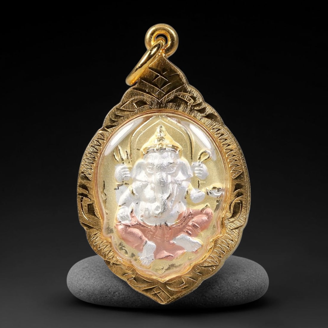 Thai Ganesha Om Symbol Votive Amulet - Gold Cased Pendant, 17YY: Ornate teardrop-shaped devotional pendant housed within intricately scroll-engraved polished gold casing, fitted with clear protective covering and a sturdy integrated hanging loop. The front face sho