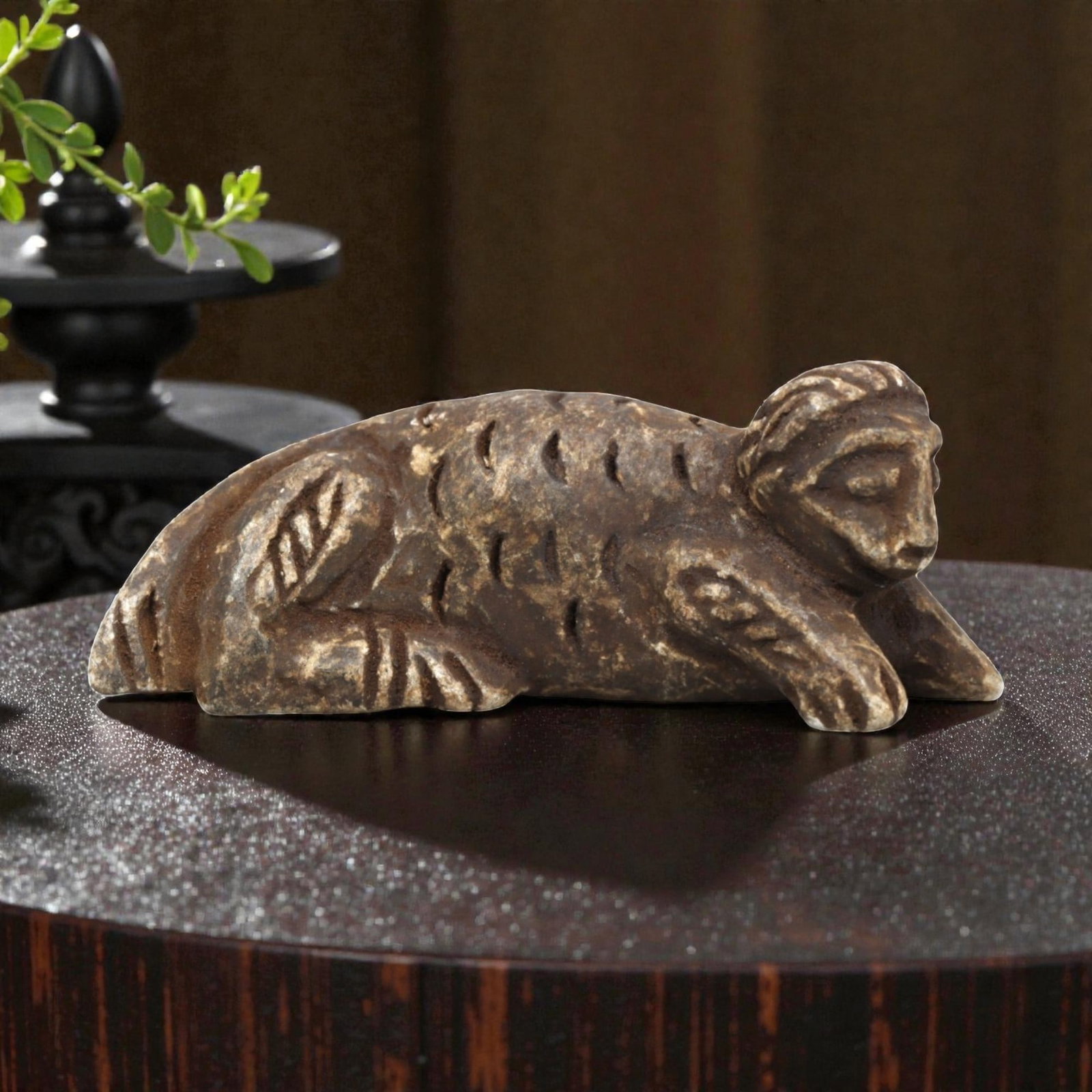 Ancient Schist Zoomorphic Amulet - Reclining Beast Figurine, 71ZP: This zoomorphic amulet is carved from schist, shaped into a reclining beast form with incised linear details defining the textured fur, stylized limbs, and facial features, including closed eyes and a