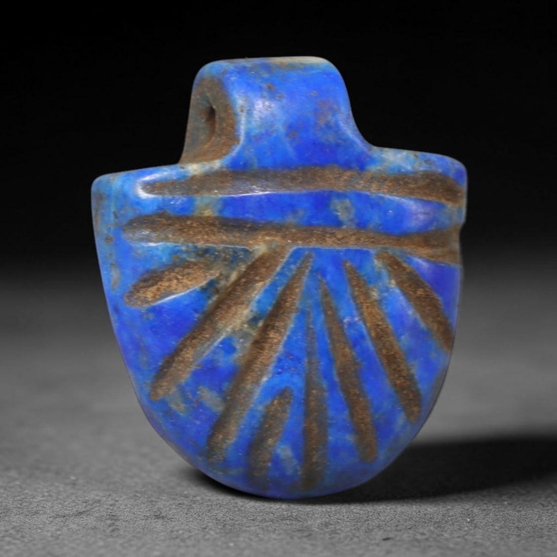 Ancient Lapis Lazuli Amulet - Near Eastern Carved Pendant, 25WT: Carved from natural lapis lazuli, this shield-form pendant features hand-incised linear motifs covering its front face, with natural pale mineral veining distributed throughout the deep blue stone mat
