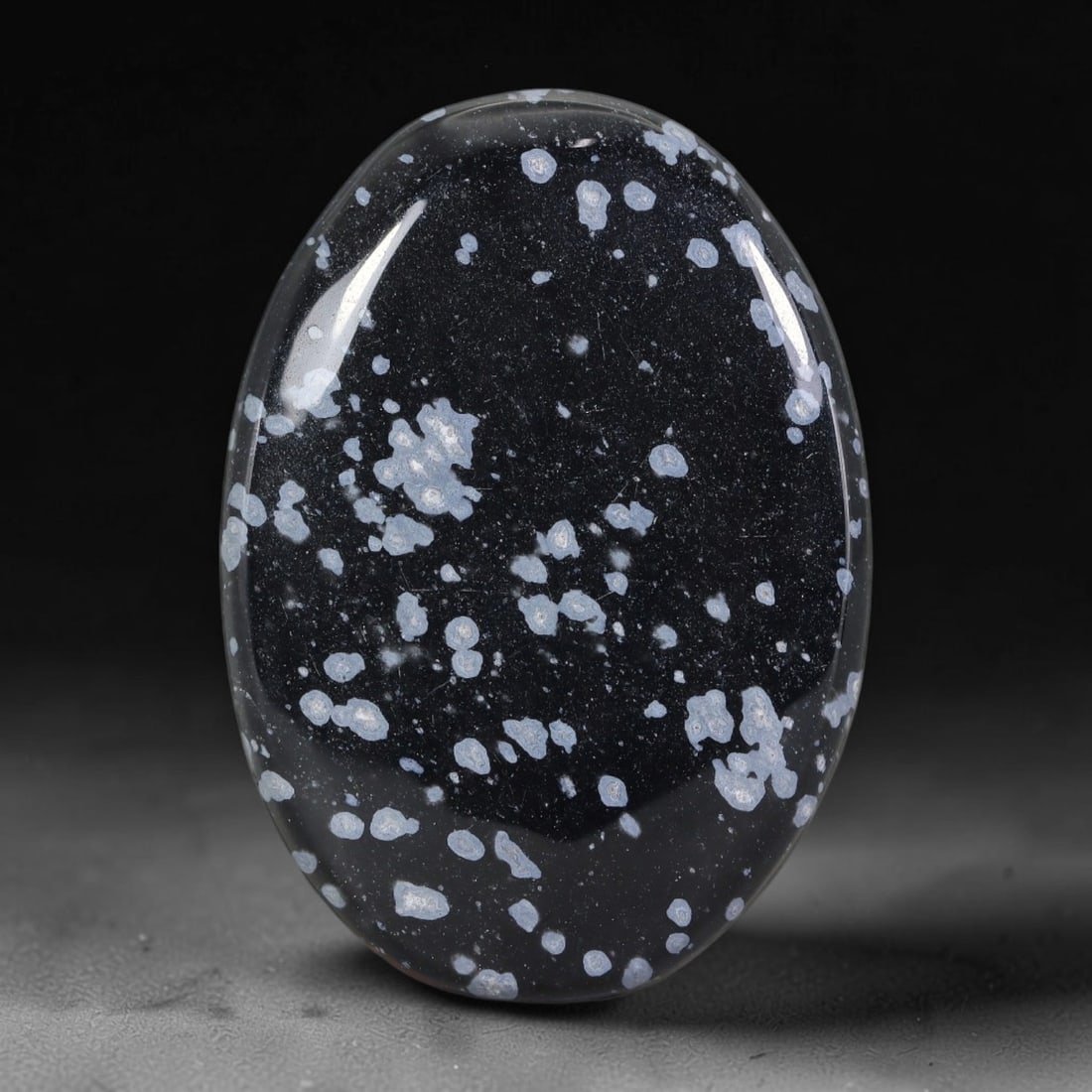 33.06 Carats Natural Snowflake Obsidian Oval Cabochon, 30XZ: Let me share with you this really nice parcel of snowflake obsidian, one smooth polished cabochon full of eye-catching natural markings! It's got a deep, jet-black glassy base, sprinkled all over with