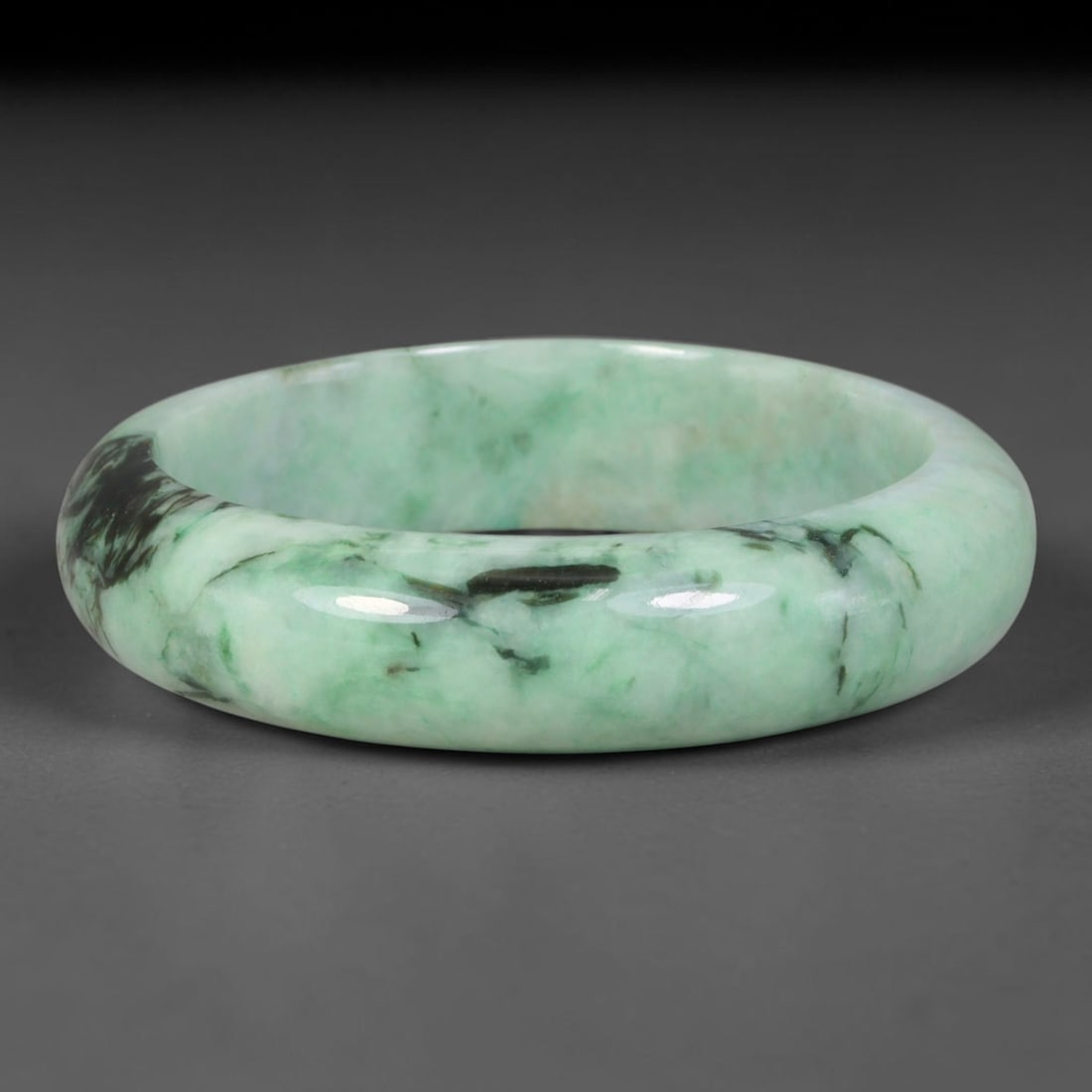 Natural Burmese Type A Jadeite Jade Bangle Bracelet, 2TD: Crafted from natural Burmese type-A jadeite, this thick wide-band bangle has a soft pale mint-green base overlaid with dramatic swirling deep moss-black green dendritic inclusions forming bold painter