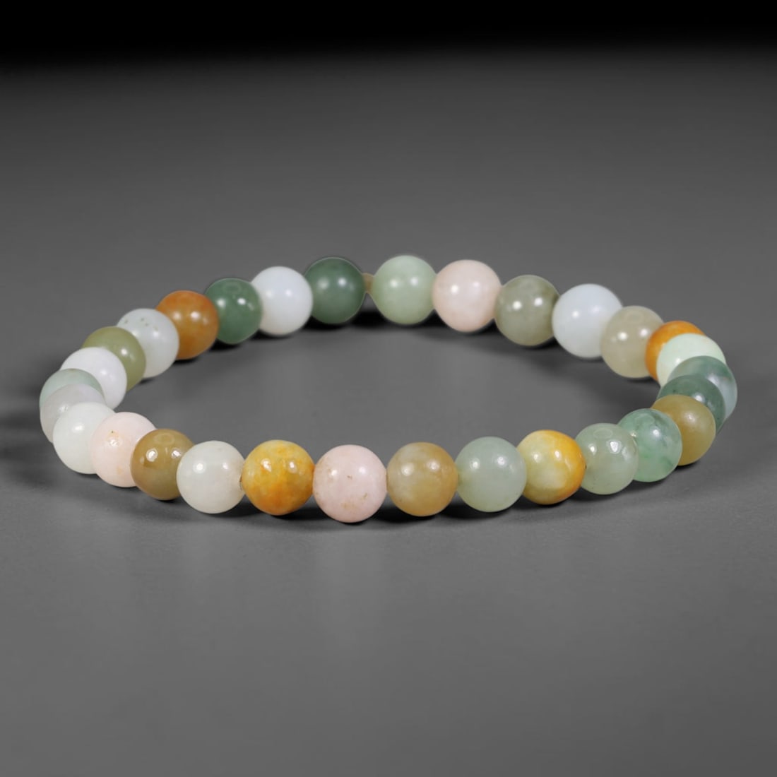 Natural Burmese Type A Multi-Colour Jadeite Jade Beaded Bracelet, 34TA: Strung from untreated natural Burmese Type A jadeite jade spherical beads with maximum bead dimension of 6.92mm, this bracelet strand features a sleek smooth polished finish showcasing mixed pale gree
