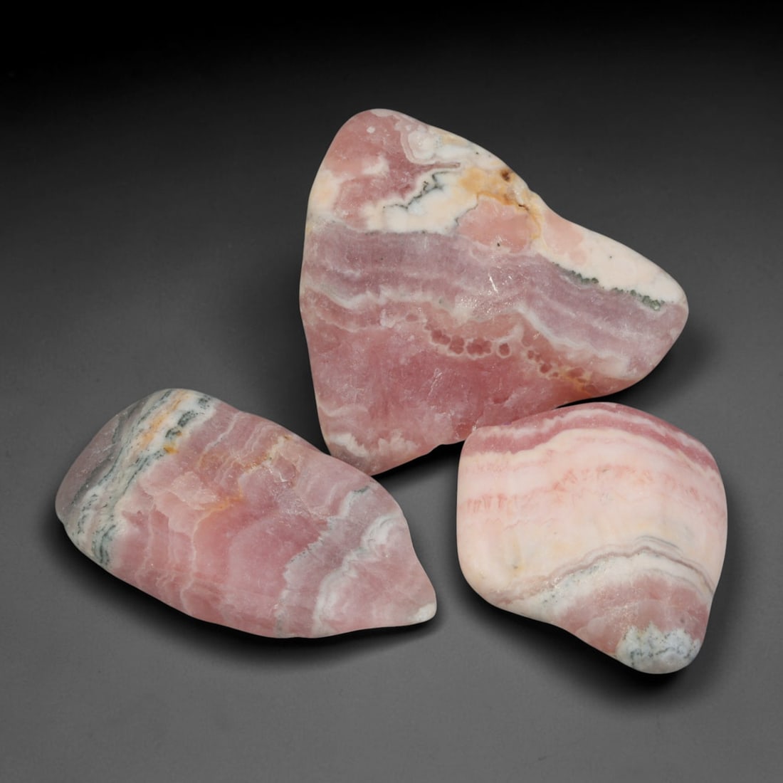 60ct 3pcs Natural Argentine Rhodochrosite Banded Tumbled Rough Set, 5YR: This listing features three individual tumbled rhodochrosite rough pieces sourced from Argentina Capillitas deposits, each showcasing distinct layered banding of soft rose pink, cream white and pale t
