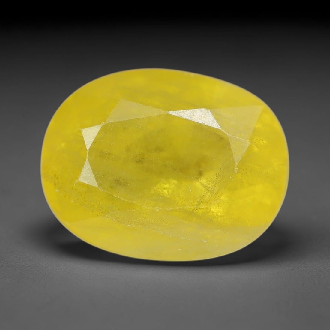 3.80 Carats Natural Yellow Sapphire Oval Faceted Loose Gemstone, 47XM: This natural yellow sapphire features a classic oval brilliant faceted cut, holding consistent warm golden-yellow color throughout the corundum crystal. Fine microscopic mineral specks and faint natur