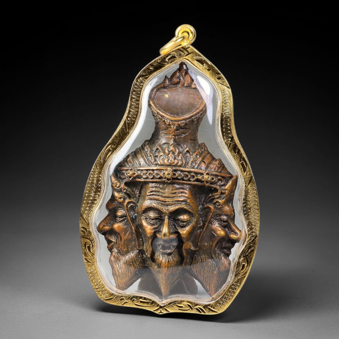 Thai Metal Three-Faced Hermit Amulet - Gold Cased Votive Pendant, 3YY: Cast metal devotional piece sculpted with central elder hermit face flanked by two profile hermit heads, topped with ornate tiered crown detailing aligned with Thai spiritual craft motifs. The metal s