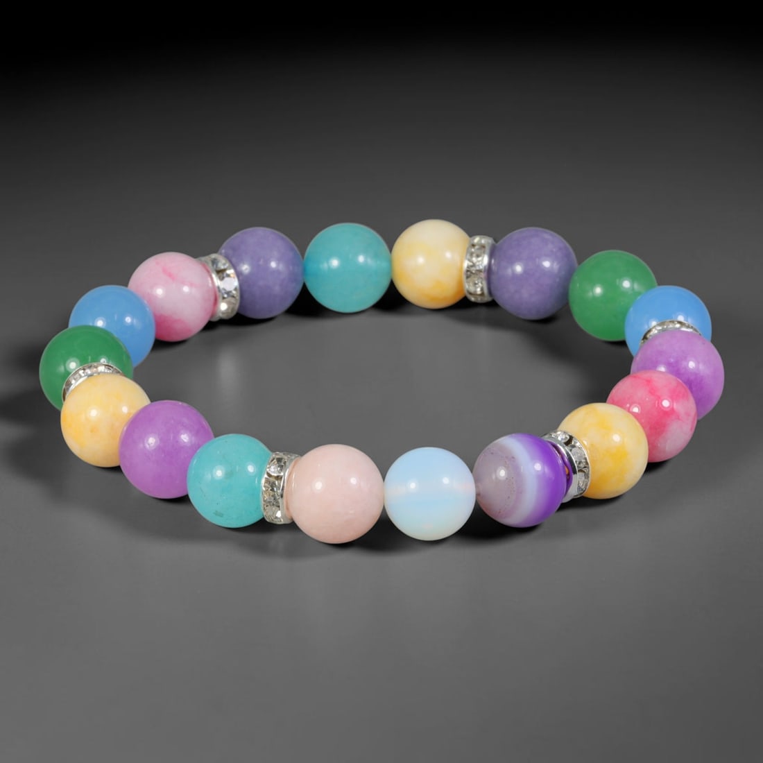 Natural Mixed Stone Beaded Bracelet - Polished Round Bead Strand, 34YM: This elastic stretch bracelet is constructed from uniformly spherical polished natural mineral beads separated by silvered metal spacers with clear crystalline inlays. The hard stone features a full s