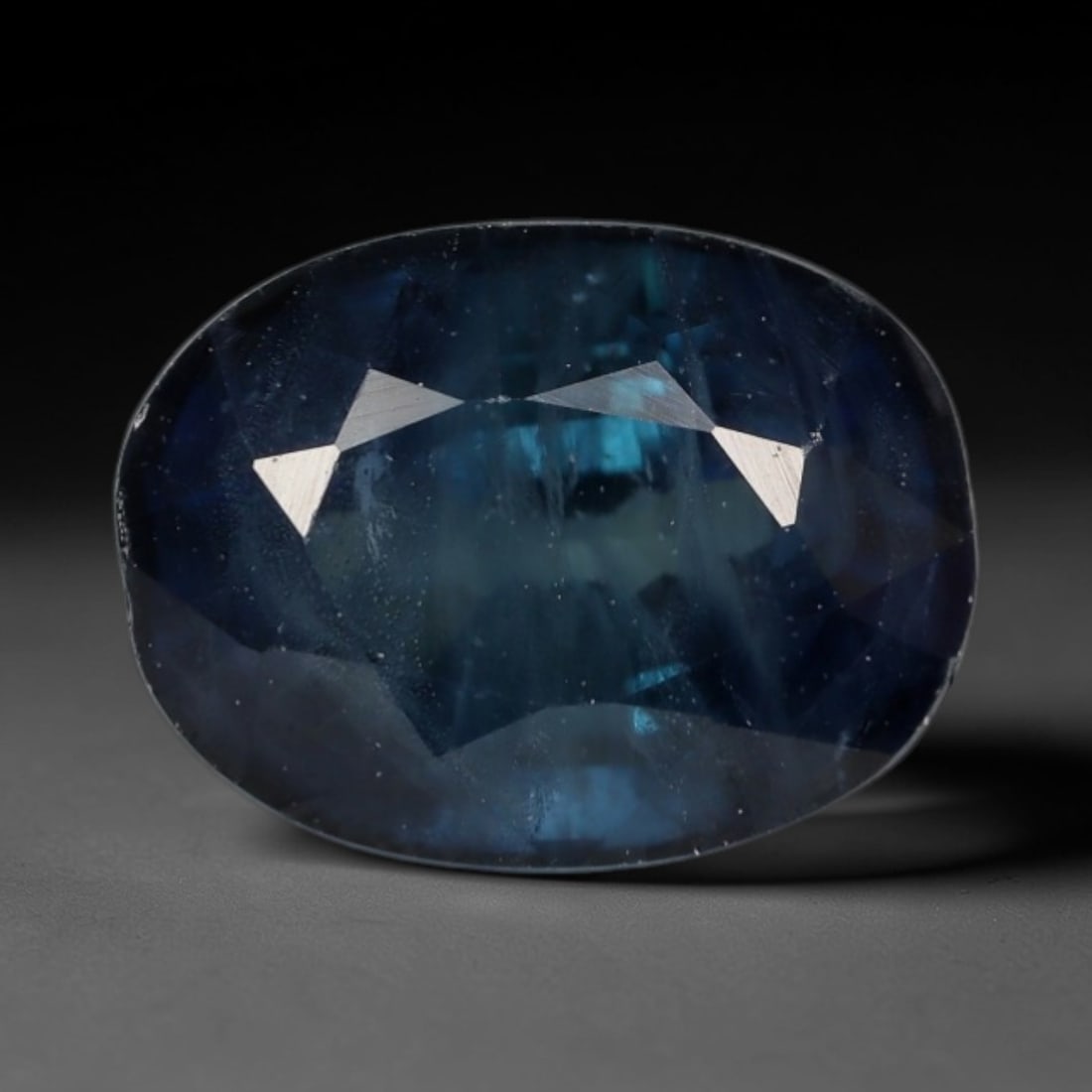 2.16ct Natural Madagascar Teal Blue Sapphire Oval Loose Faceted Gemstone, LZ299: This natural oval faceted sapphire mined from Madagascar weighs 2.16 carats with exact dimensions of 7.8x6.0x4.9mm. It exhibits a distinctive layered teal-blue hue, blending deep navy blue with vivid 