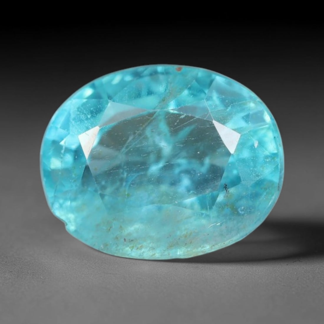 1.55 Carats Natural Bright Cyan Blue Apatite Oval Faceted Loose Gemstone, 16WW: This apatite is sourced from natural mineral deposits and processed with precise faceting and uniform high-gloss polishing by professional lapidary craftsmanship. Natural fibrous textures and tiny sca