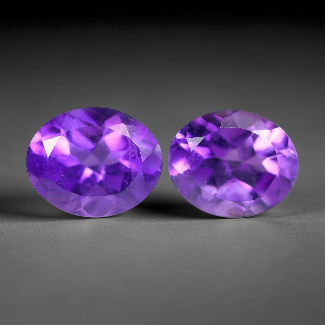 5.40 Carats Natural Purple Amethyst Oval Faceted Pair Loose Gemstone, 26XX: Natural crystalline amethyst material processed with precision oval faceting for the matched gem pair, exhibiting rich saturated violet hue alongside subtle natural internal inclusions inherent to unt