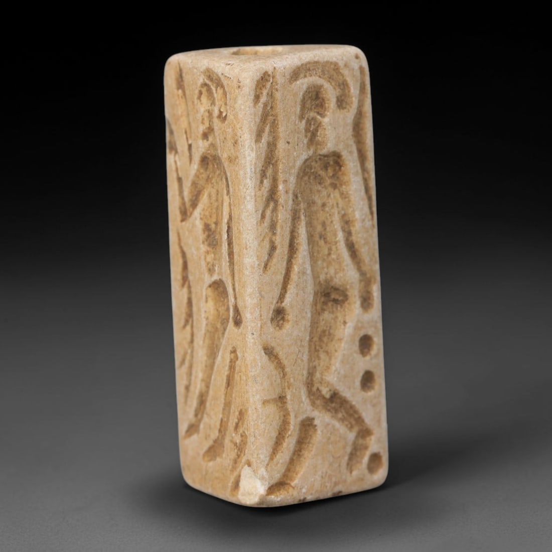 Ancient Near Eastern Hand Carved Stone Stamp Bead Talisman, 45WT: Slender antique perforated stone artifact hand-fashioned from natural pale sedimentary stone, originating from Ancient Near Eastern civilizational craft and ritual traditions. Dense fine-grained stone