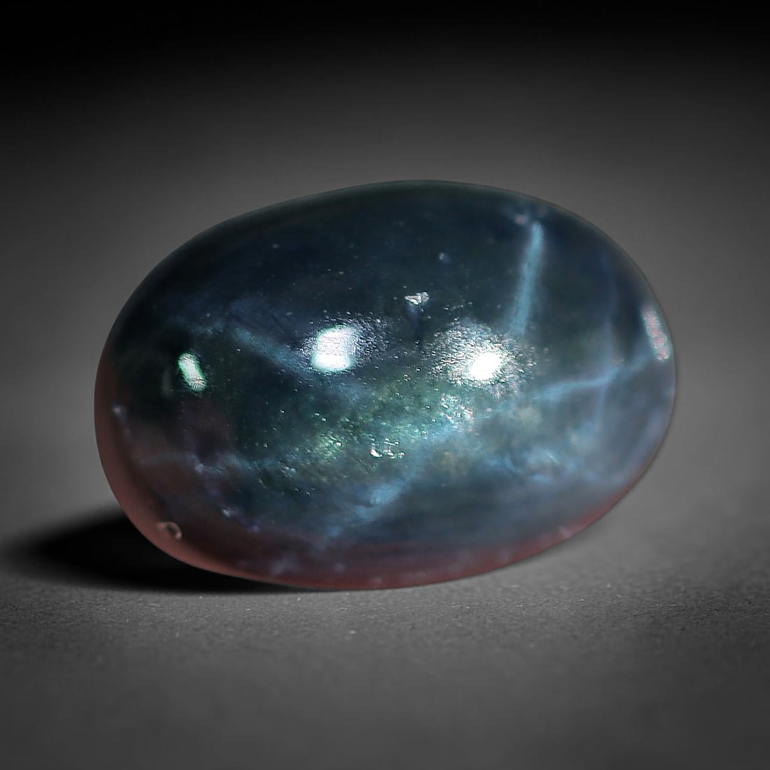 2.45 Carats Ocean Mist Star Sapphire Oval Cabochon - Natural Loose Gemstone, 32XC: This oval star sapphire shimmers with an ethereal ocean-mist blue hue, shifting from deep indigo to soft teal with subtle green undertones. A bright six-rayed star effect glides across its smooth, pol