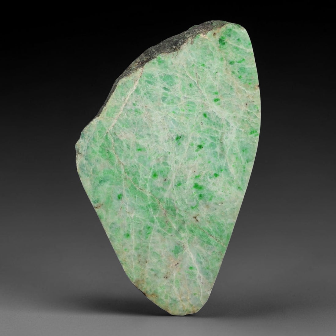 515ct Natural Type A Burmese Jadeite Jade Sliced Rough, 100YN: This specimen is a sliced rough block of natural Type A Burmese jadeite jade. The interior displays natural colour zoning with visible mineral veining and crystalline patterns typical of unprocessed j