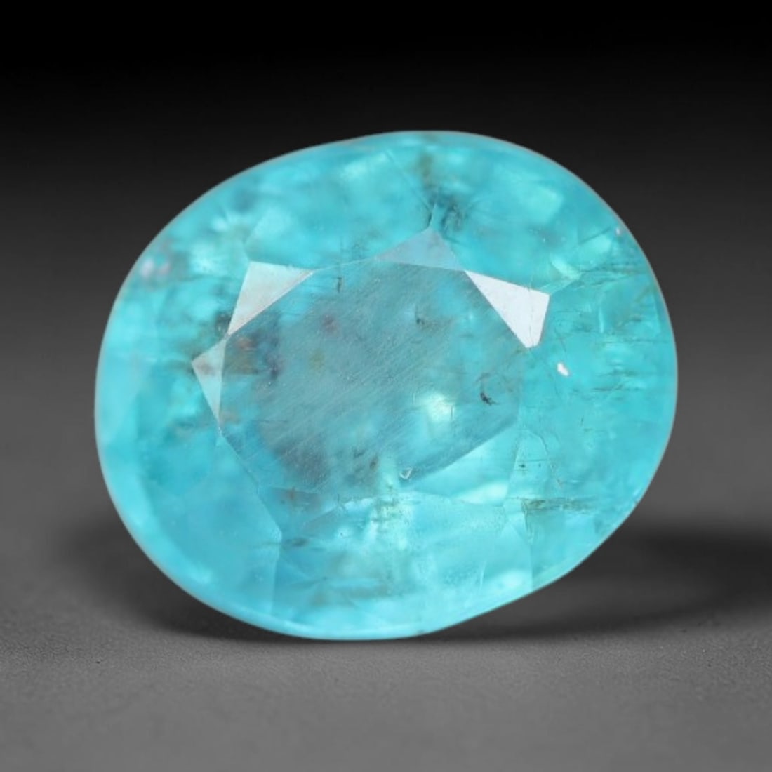 1.48 Carats Natural Bright Cyan Blue Apatite Oval Faceted Loose Gemstone, 19WW: This apatite is sourced from natural mineral deposits and processed with precise faceting and uniform high-gloss polishing by professional lapidary craftsmanship. Natural fibrous textures and tiny sca
