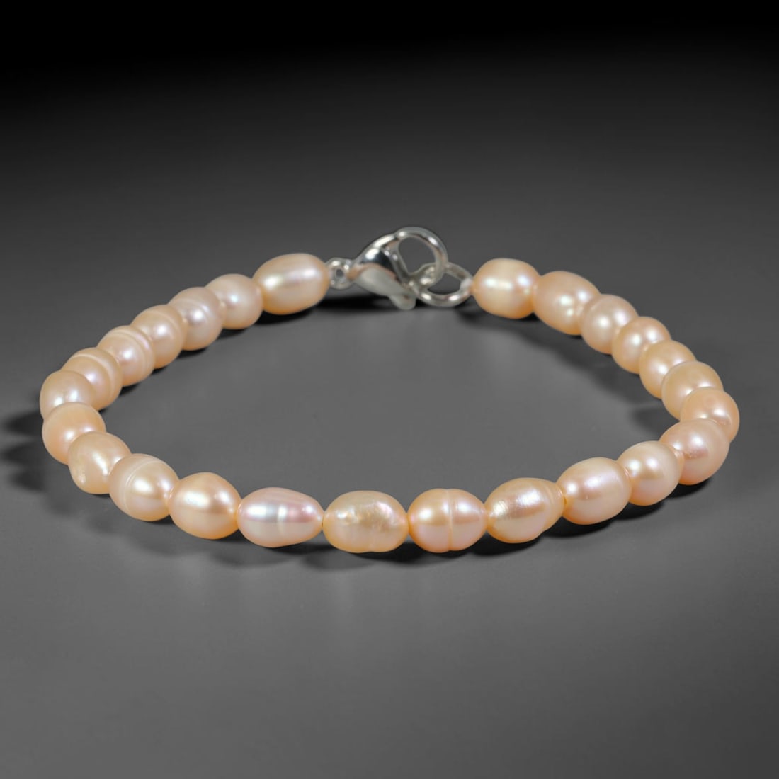 Natural Freshwater Pearl Bracelet - Baroque Peach Blush Pearl Strand, 73YM: Composed of petite organic baroque natural freshwater pearls carrying soft peach blush pearlescent luster, each bead holding delicate asymmetrical oval shapes formed through unrefined natural freshwat